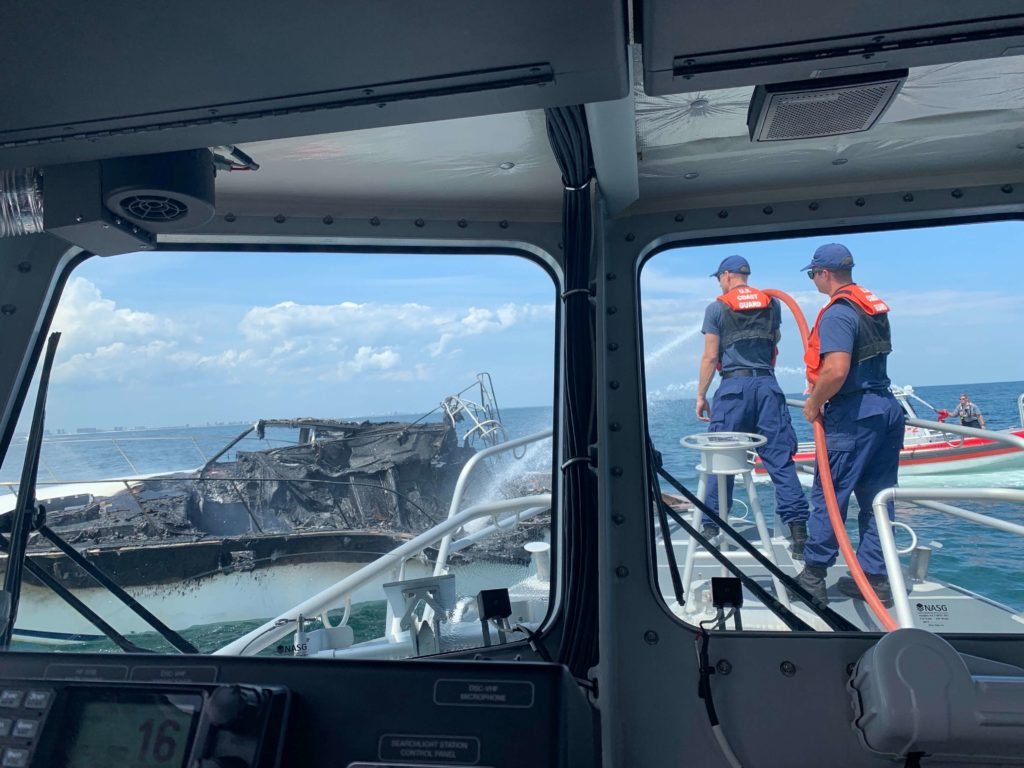 Smoke from a charter vessel fire is seen off the bow of a 45-foot rescue boat dispatched from Station Pensacola near Perdido Pass, Alabama, July 27, 2019. The crew worked with the local fire department as well as good samaritan mariners to put out the fire. 