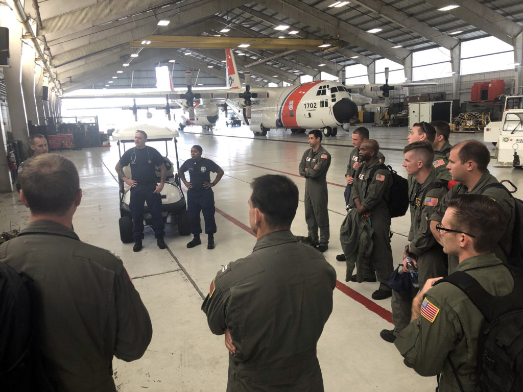 Coast Guard air crews and health service technicians are briefed at Coast Guard Air Station Clearwater before a C-130 flight to Andros Island in preparation for Hurricane Dorian response, U.S. Coast Guard photo by Petty Officer 1st Class Ayla Kelley.