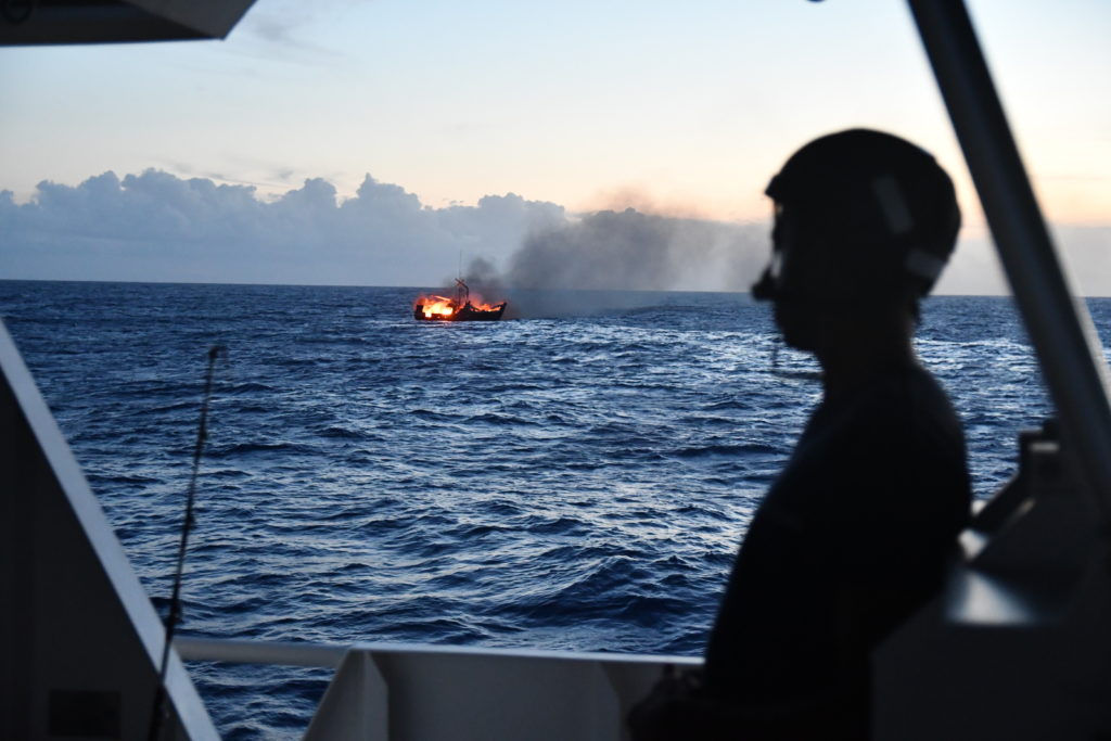 The USCGC Joseph Gerczak (WPC 1126) remains on scene to ensure the burning vessel Miss Emma