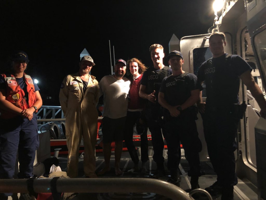A Coast Guard Station St. Petersburg boatcrew poses for a photo with three survivors at Station St. Petersburg, 
