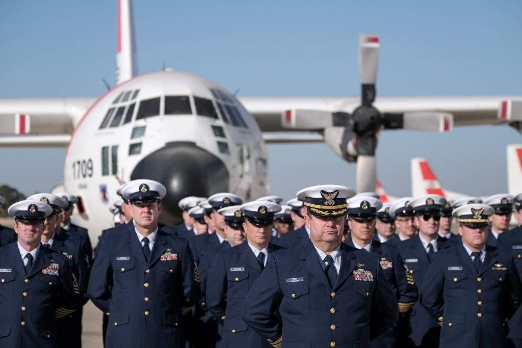 Cmdr. Sean Green, the Coast Guard Air Station Sacramento operations officer stands in front of Coast Guard Air Station personnel assembled during a remembrance ceremony, Oct. 29, 2019, at Coast Guard Air Station Sacramento for fallen aircrews for the 10th anniversary of an aircraft collision between a Coast Guard HC-130 Hercules aircraft and a Marine Corps AH-1 Super Cobra helicopter.