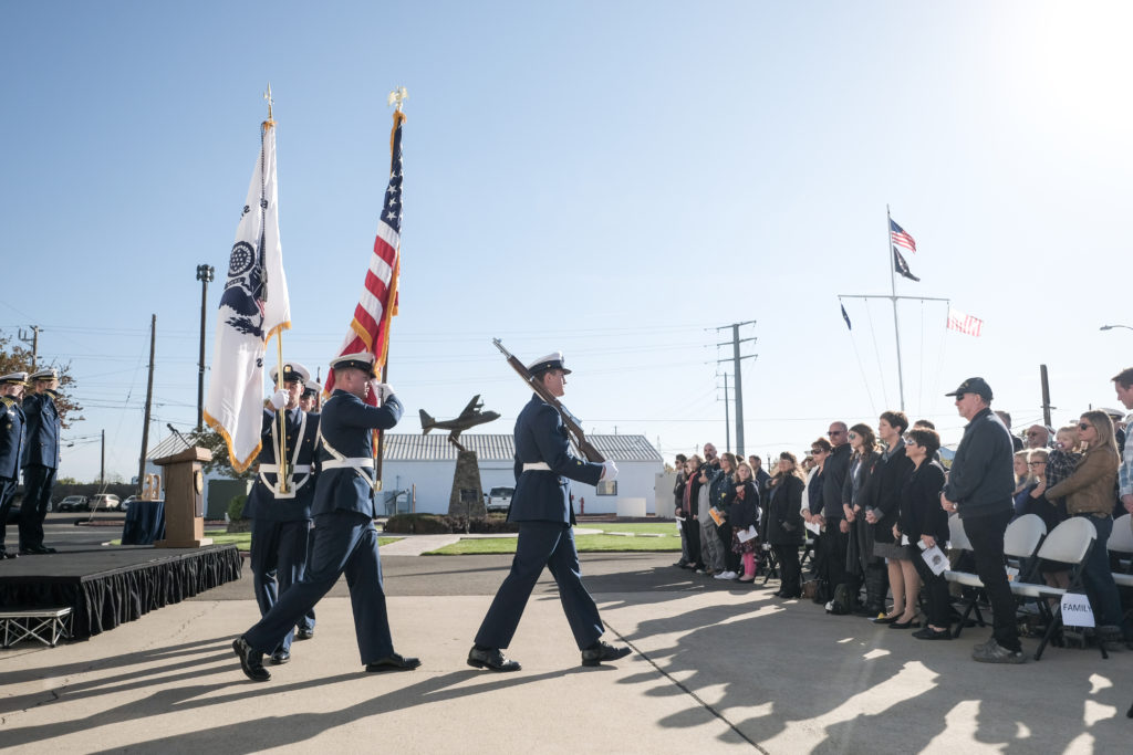 Members of a Coast Guard color guard present the colors during a remembrance ceremony, Oct. 29, 2019, for fallen aircrews for the 10th anniversary of an aircraft collision between a Coast Guard HC-130 Hercules aircraft and a Marine Corps AH-1 Super Cobra helicopter.
