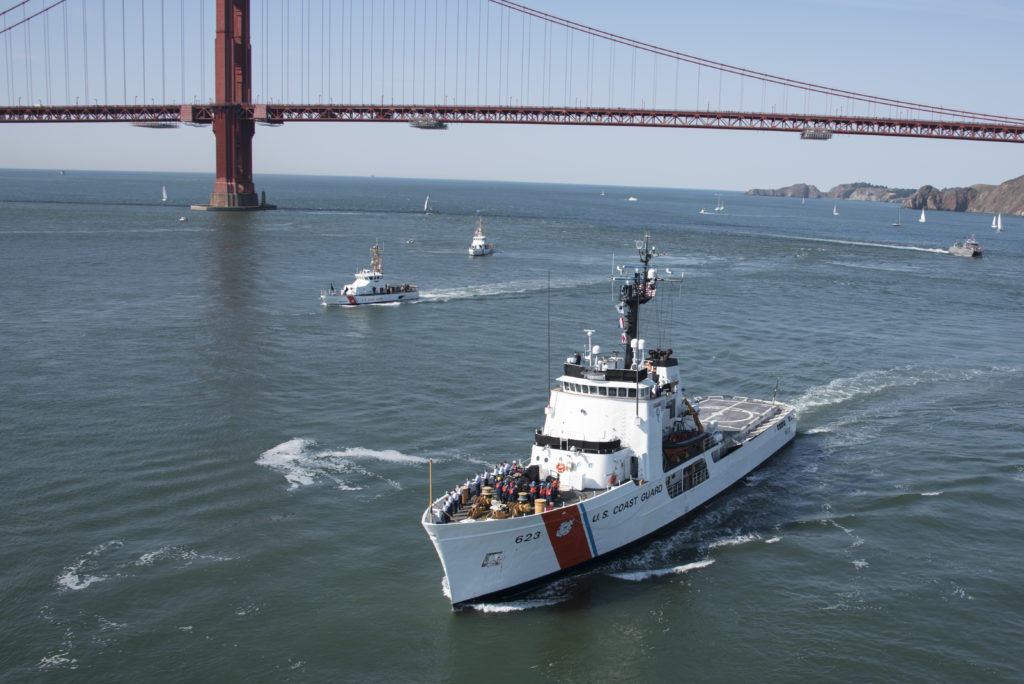 Several 87-foot Coast Guard Cutters escort the Coast Guard Cutter Steadfast, a 210-foot vessel homeported out of Warrenton, Oregon, as it transits through San Francisco Bay during San Francisco Fleet Week Parade of Ships, October 11, 2019.