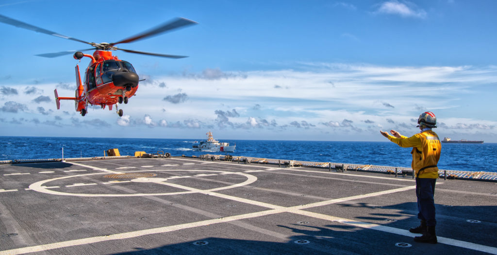 An MH-65 Dolphin helicopter crew assigned to Helicopter Interdiction Tactical Squadron (HITRON) lands on the flight deck of the Coast Guard Cutter James while conducting hurricane relief operations in the Caribbean Sea, Sept. 6, 2019. 
