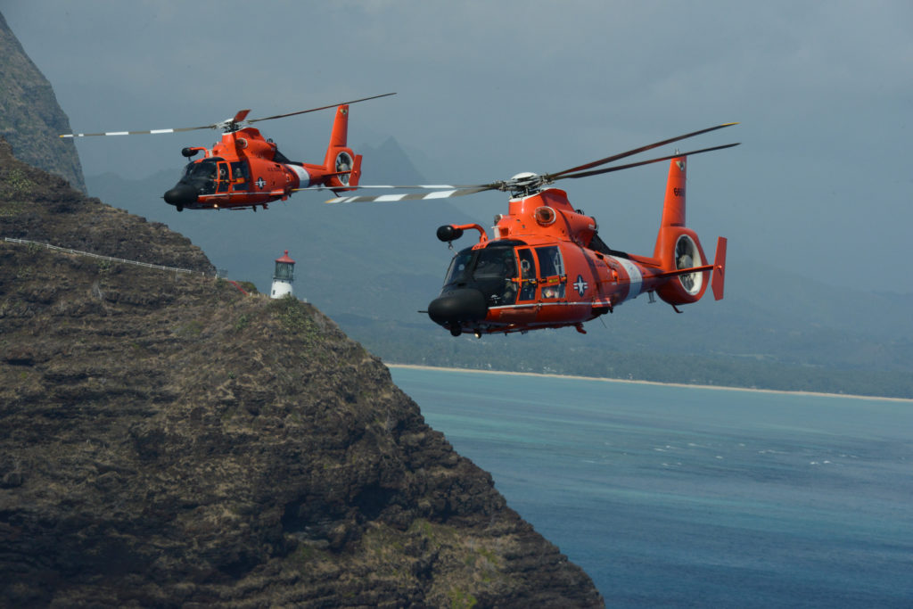 two MH-65 Dolphin helicopter crews from Coast Guard Air Station Barbers Point conduct a practice formation flight around the Island of Oahu. Missing Helicopter Kauai