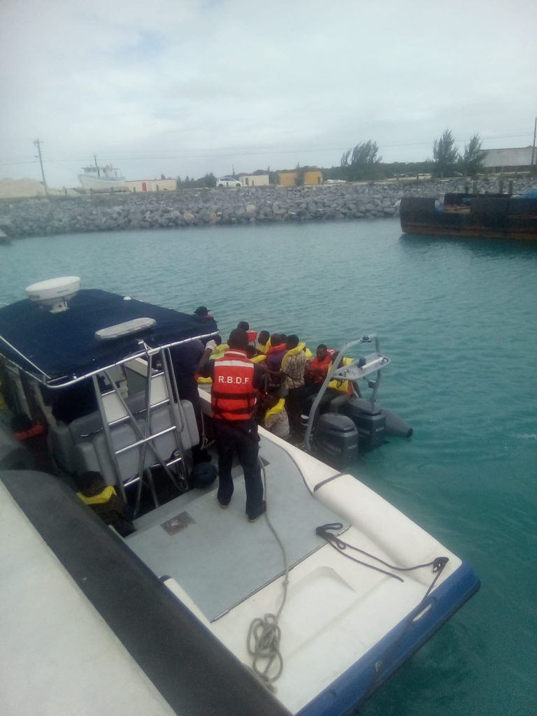 The Turks and Caicos Police Force transfers search and rescue survivors ashore