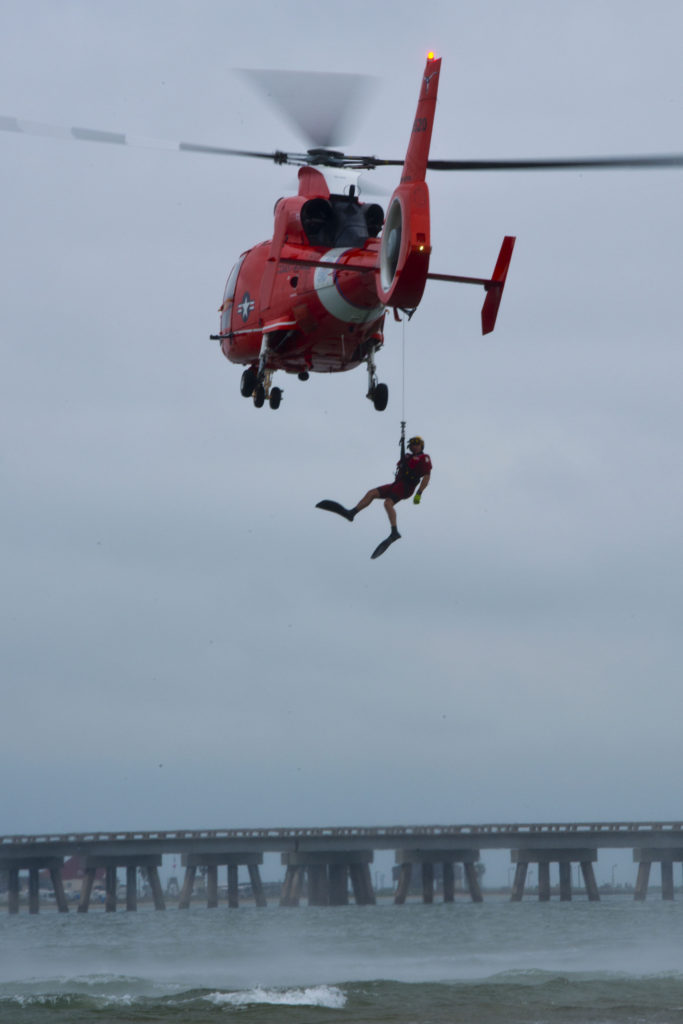 Coast Guard rescue swimmer is hoisted from San Luis Pass, Texas, during a rescue exercise. Coast Guard crewmembers and senior leadership from Air Station Houston conducted the training to sharpen skills and to gain the prospective of rescuees. 