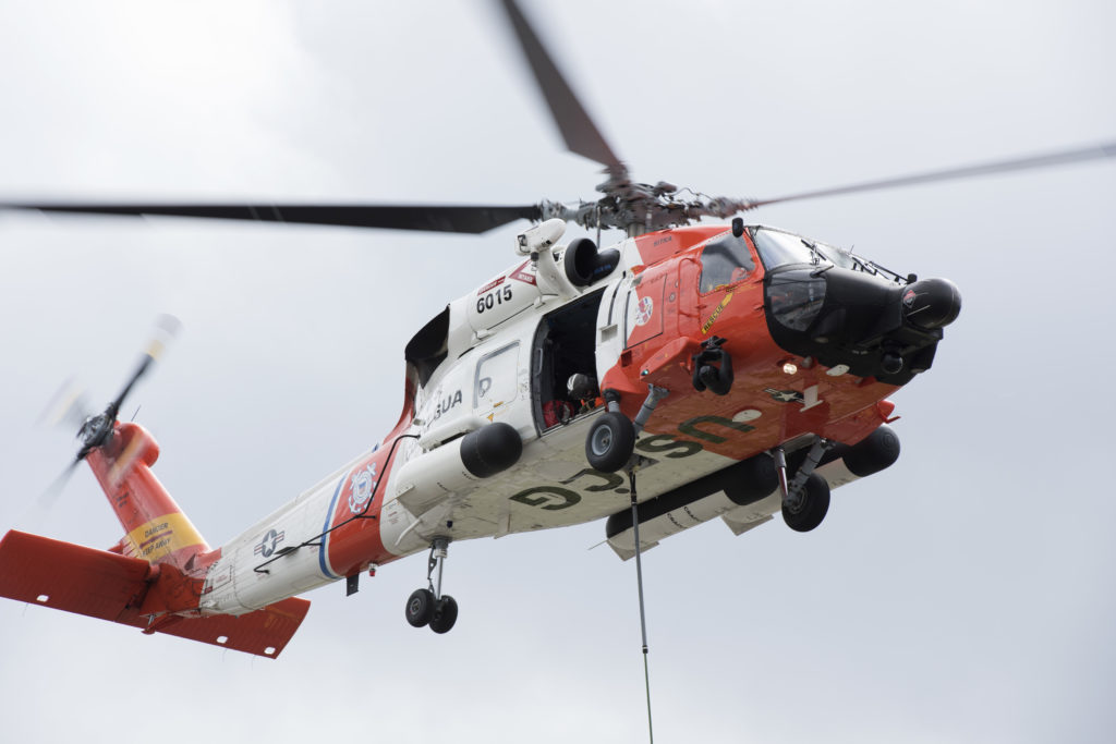 An MH-60 Jayhawk helicopter crew from Coast Guard Air Station Sitka hoists approximately 1,300 feet of oil containment boom using cargo nets in Juneau, Alaska, June 26, 2018. 