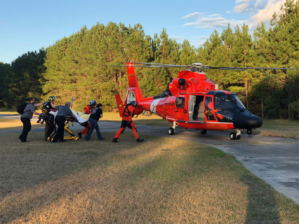 A Coast Guard Air Station Savannah MH-65 Dolphin helicopter crew prepares to transport overdue kayaker David Larkin, Jan. 4, 2020, after partner agencies located him. At 8 p.m. Jan. 3, Coast Guard Sector Charleston watchstanders received a notification from a concerned family member stating that Larkin departed from Belvedere Island Plantation and intended to transit Cross Tide Creek to Half Moon Marina and did not return when expected. 