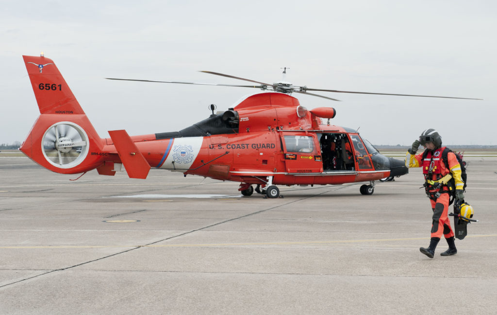 Petty Officer 2nd Class Bradley Pigage, an Air Station Houston rescue swimmer, returns to the air station with the MH-65 Dolphin aircrew after they located an overdue boater near Port Arthur, Texas. Coast Guard vessel Galveston