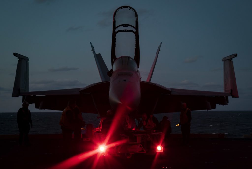 Sailors assigned to the aircraft carrier  USS Gerald R. Ford (CVN 78) air department prepare to move an F/A-18F Super Hornet, assigned to Air Test and Evaluation Squadron (VX) 23, from an aircraft elevator to the hangar bay. Ford is currently conducting aircraft compatibility testing to further test its Electromagnetic Aircraft Launch System (EMALS) and Advanced Arresting Gear (AAG). 