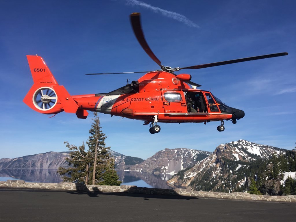 A Coast Guard helicopter crew transport the located man in Loon Lake