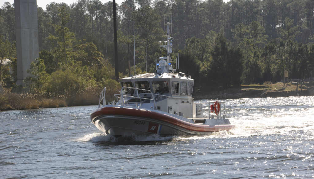 Coast Guard aircrew hoists 2 adults, 1 child from sailboat near Brant Island, North Carolina. 45-foot Response Boat-Medium. Coast Guard Station Hobucken.