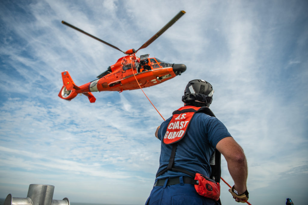 Coast Guard rescue 3 people from capsized vessel near Lake Borgne, Louisiana. MH-65 Dolphin Air Station New Orleans.