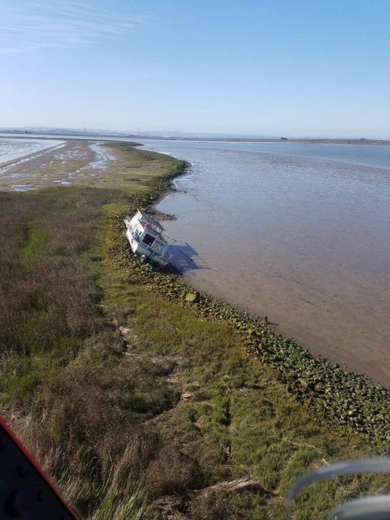 Coast Guard aircrew rescues 2 from aground houseboat in Napa River.