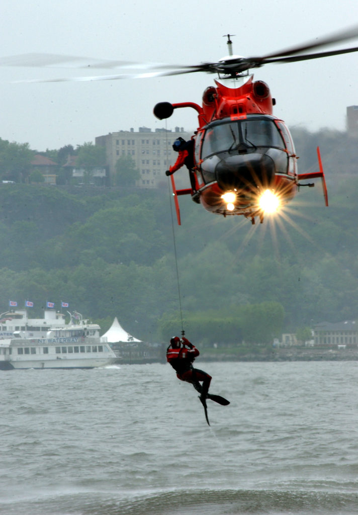 MH-65 helicopter from Air Station Atlantic City lowers a rescue swimmer during a Coast Guard search and resccue demonstration during fleet week.