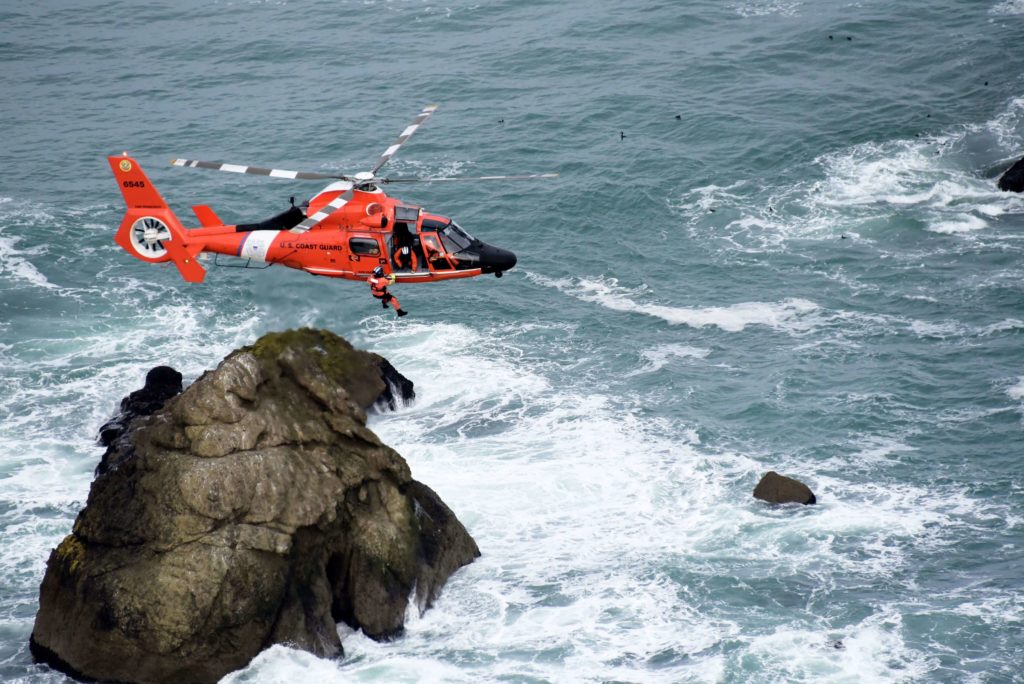 Coast Guard Air Station San Francisco MH-65 Dolphin aircrew rescue man, dog from sailboat near Hercules