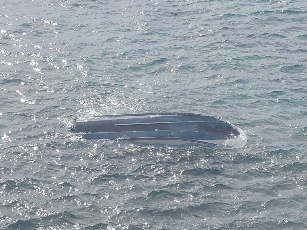 Coast Guard, partners rescue mariners from overturned vessel off Oahu. MH-65 Barbers Point