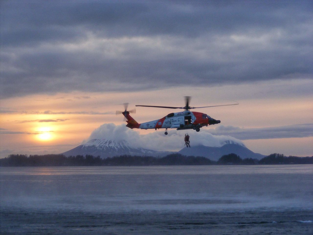 Coast Guard MH-60T rescue man near Cape Fairweather, Alaska