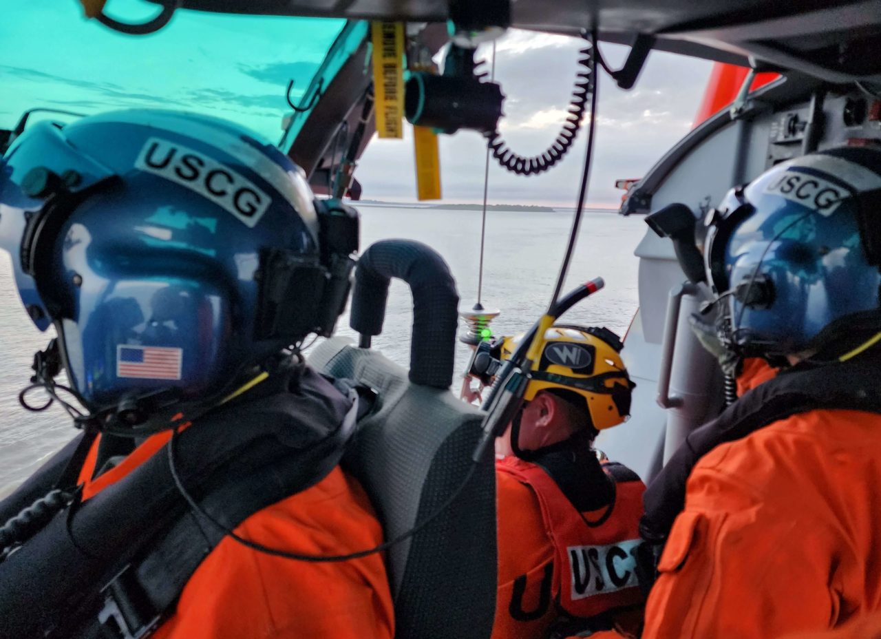 Coast Guard MH-65 rescue man in Ossabaw Sound, Georgia